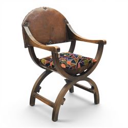 Early 20th century mahogany Savonarola chair, arched leather back with brass studwork, cur...