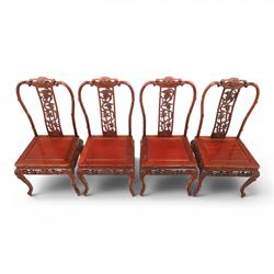 20th century Chinese ornately hardwood dining table and chairs, circular table with 'Lazy Susan' top with pierced carved frieze, raised on a quadriform base with carved foliate detail, the chairs en suite with carved pierced detailing  