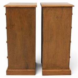 Traditional walnut inlaid pair of tall bedside chests, figured top with inlaid banding, four graduating drawers with wooden turned knobs, raised on a plinth  