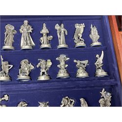 Danbury Mint 'The Fantasy of the Crystal' chess set consisting of mythical pewter chess pieces within a wooden case with chess board lid, together with 16 additional chess pieces in a wooden display case.