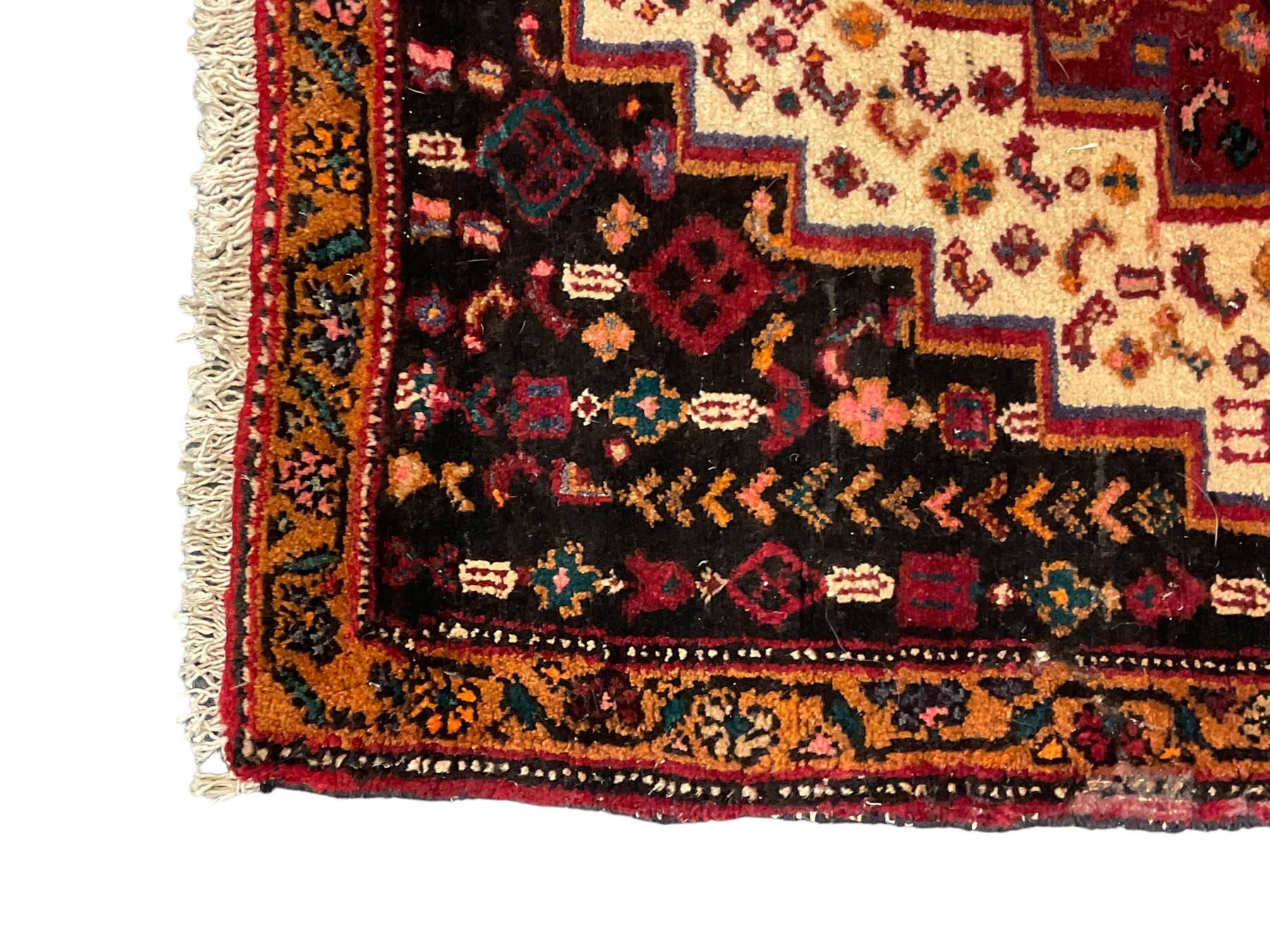 Small Hamadan dark indigo ground rug, central ivory and maroon lozenge with geometric decoration, guarded border with repeating stylised plant motifs, together with three others (4)