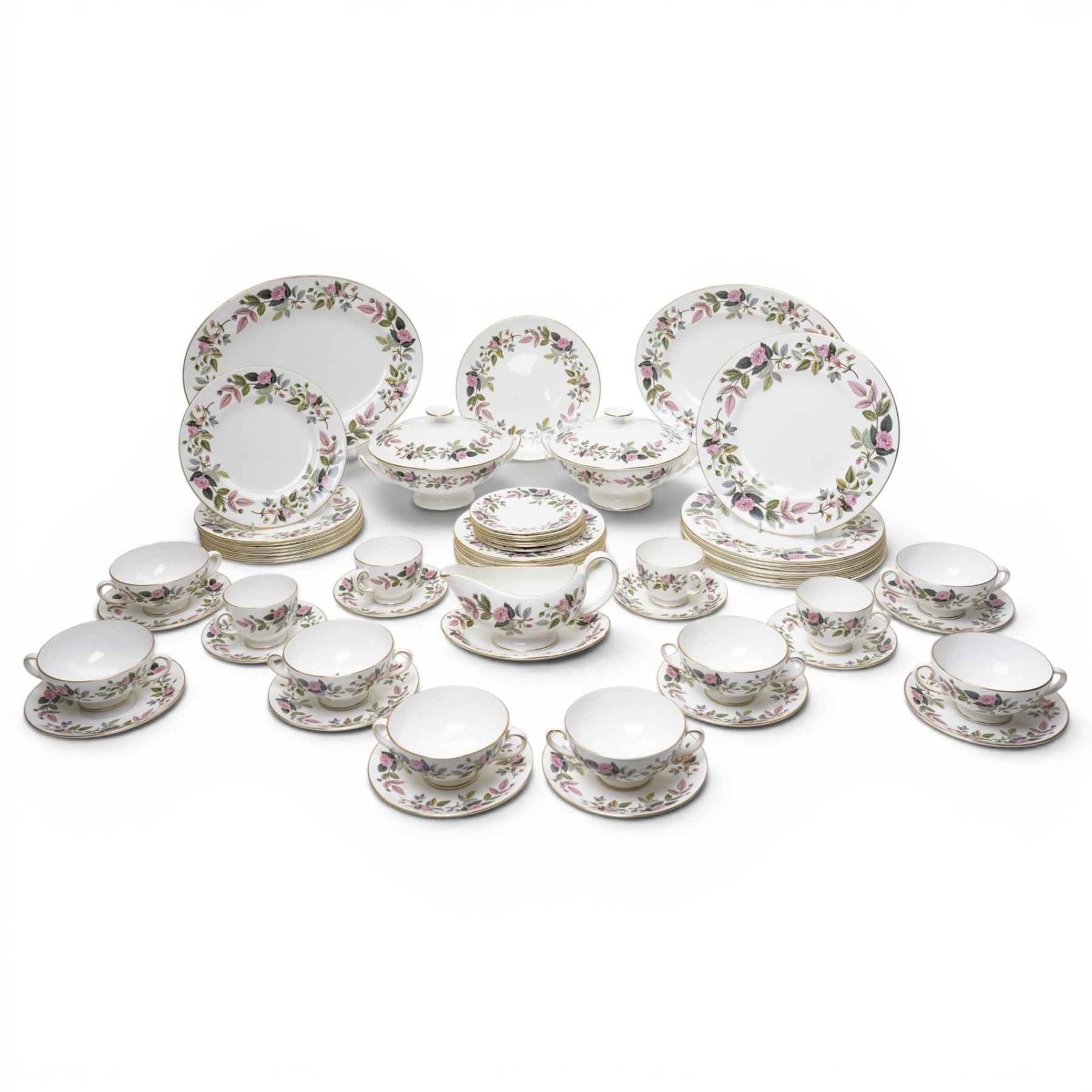 Wedgwood Hathaway Rose pattern tea and dinner wares, comprising two covered tureens, two oval serving dishes, eight dinner plates, eight dessert plates,  six side plates, eight soup bowls and stands, four teacups and saucers, and a sauce boat and stand
