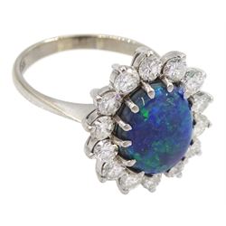 White gold oval black opal and round brilliant cut diamond cluster ring, opal approx 11.4mm x 8.5mm x depth 5mm, total diamond weight approx 1.05 carat, stamped 18ct