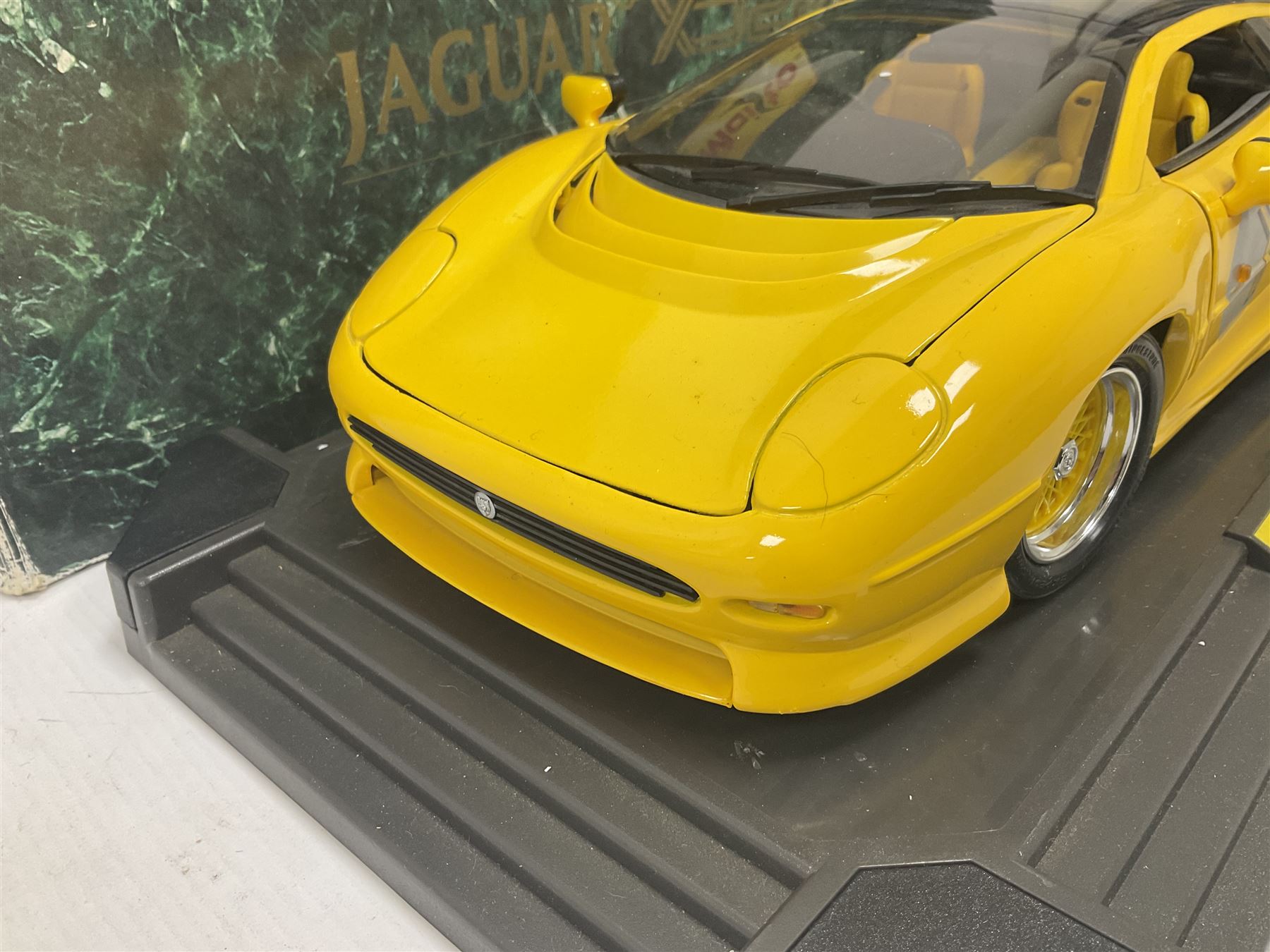 Two Maisto 1:12 scale Jaguar XJ220 ‘Racing’ cars in yellow, both on plinths in original boxes 