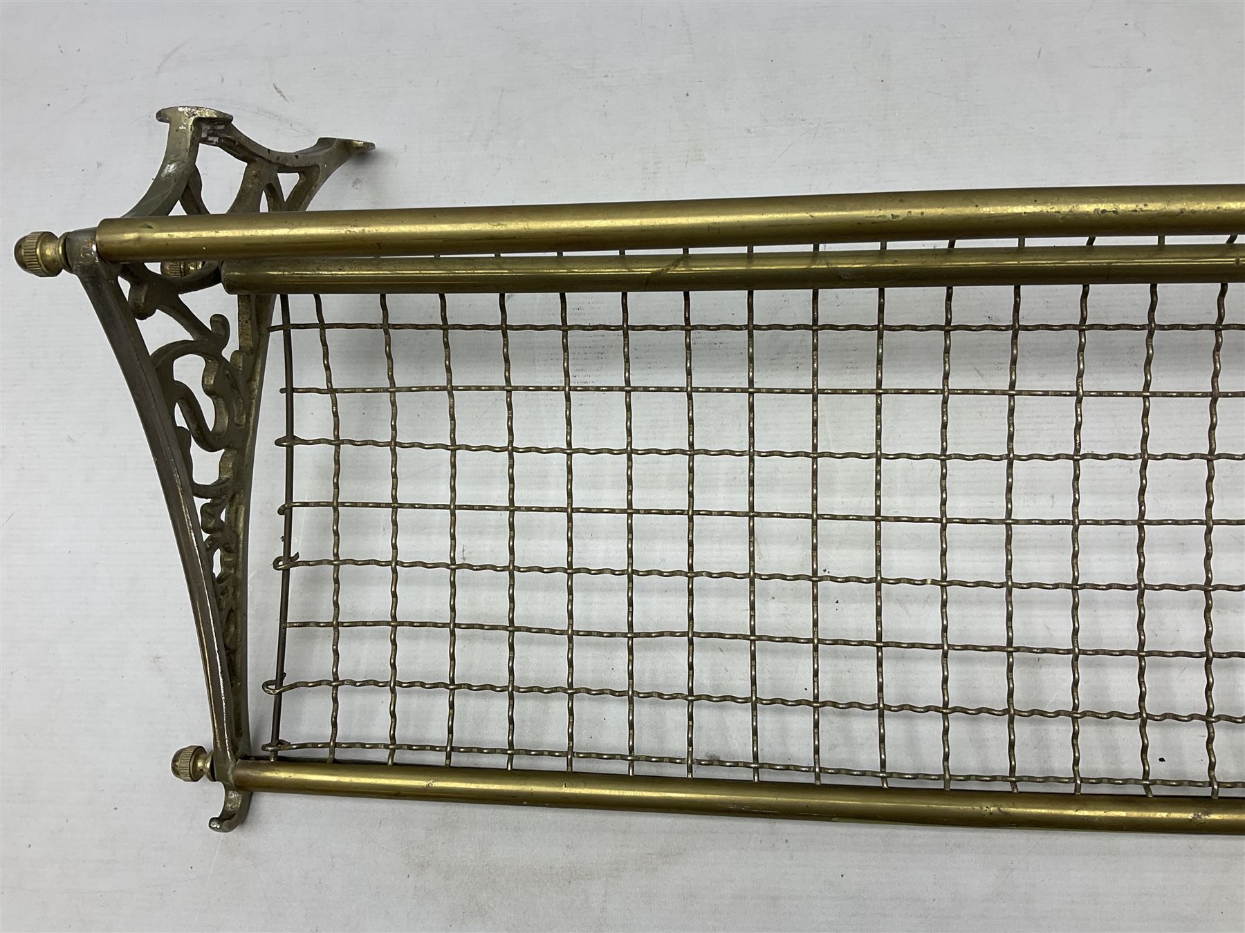 Railway interest - carriage compartment style wall mounting brass and mesh luggage rack, the ends cast with the initials NSWR (New South Wales Railroad) L77cm