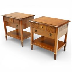Brigitte Forestier - pair of cherry wood bedside cabinets, moulded rectangular top above two drawers, the top drawer with reeded panels flanking a brass circular pull, the lower drawer with two brass pulls, on square tapering supports united by a full length undertier