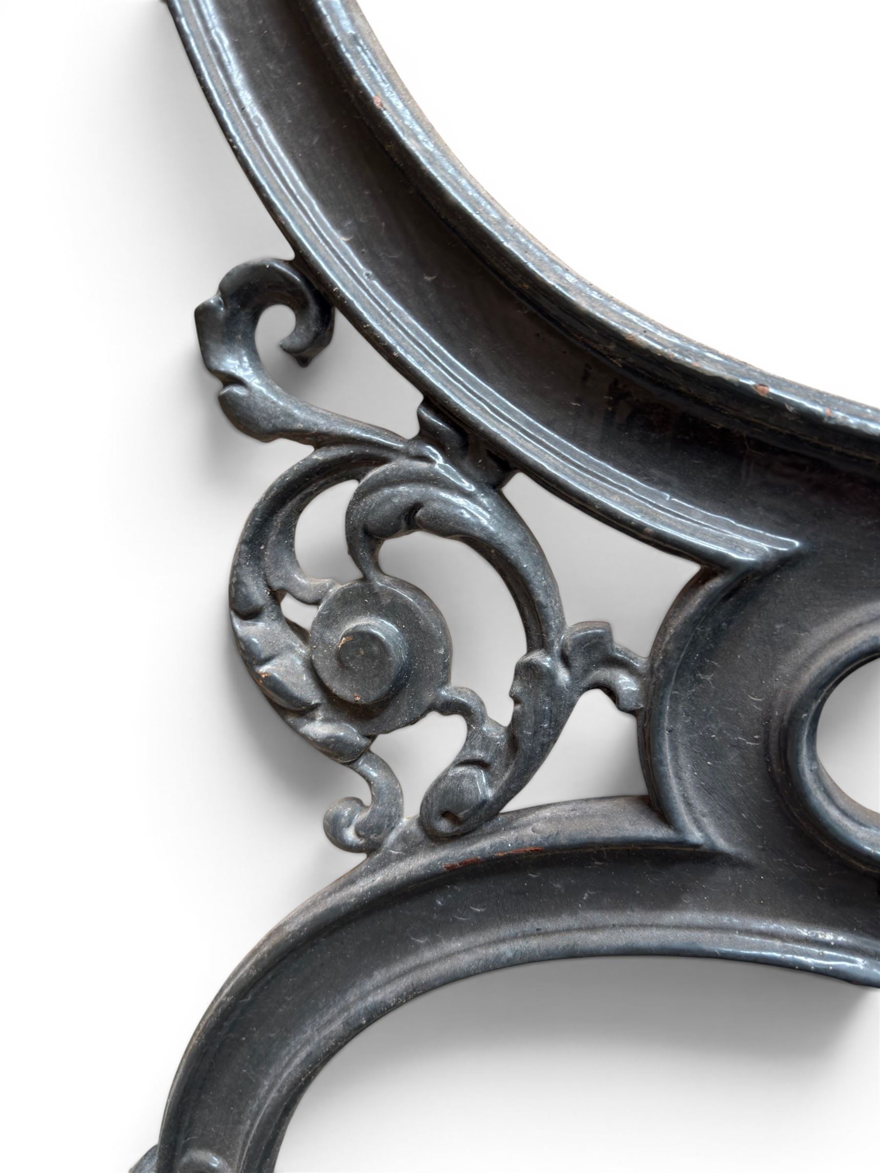 Yates Haywood - pair of 19th century cast iron bench ends, winged griffin detail, arched legs with rope turned decoration, finish in green paint, registration number 206550, first registered 8 March 1867 (see illustration), length as required