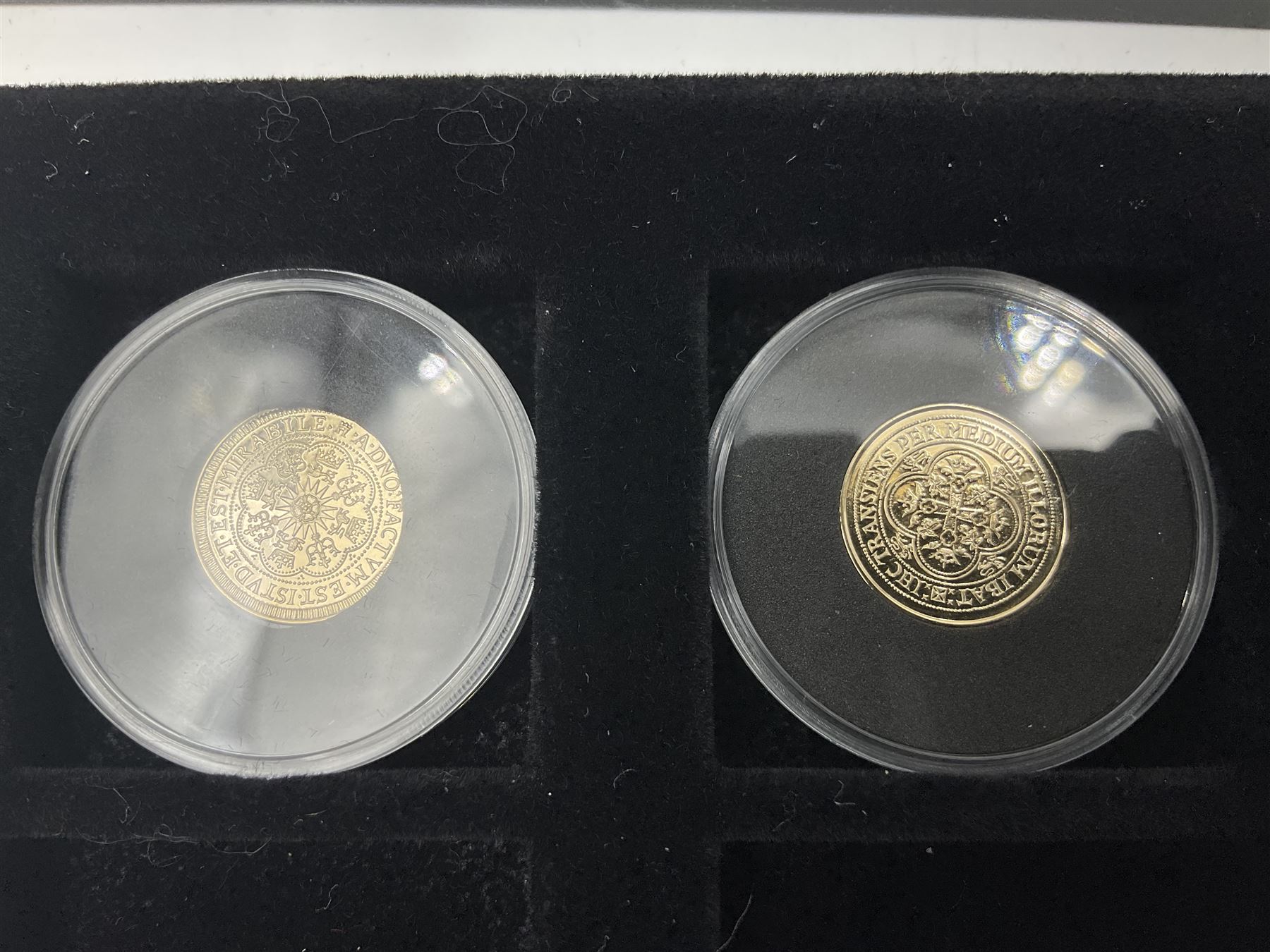 Sixteen hallmarked 9ct gold replica coins from 'The Historic Coins Of Great Britain Museum Gold Collection', housed in a Westminster display case, overall weight approximately 51.3 grams