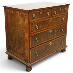 William & Mary period laburnum and walnut oyster-veneered chest, the rectangular top with canted corners and walnut banded edge, profusely decorated with oyster veneer and fruitwood stringing in concentric circles, fitted with two short over three long drawers with fruitwood banding, each fitted with original pressed brass escutcheons and pull handles, lower moulded edge over original bun feet