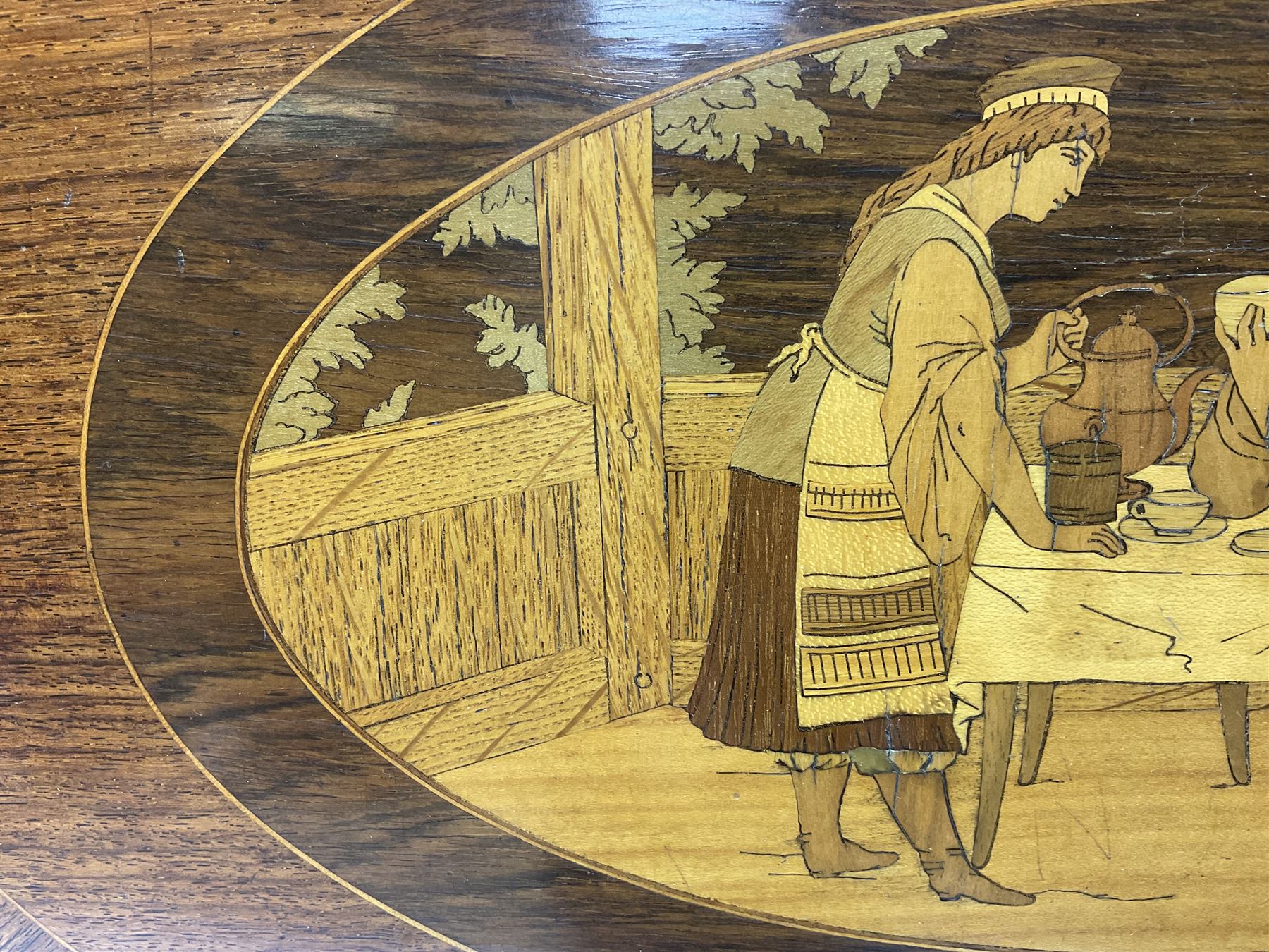 Late 19th/early 20th century mahogany and marquetry inlaid tray, of oval form with twin scrolled handles and moulded border, the central panel inlaid with figures seated at a table drinking tea, L99cm