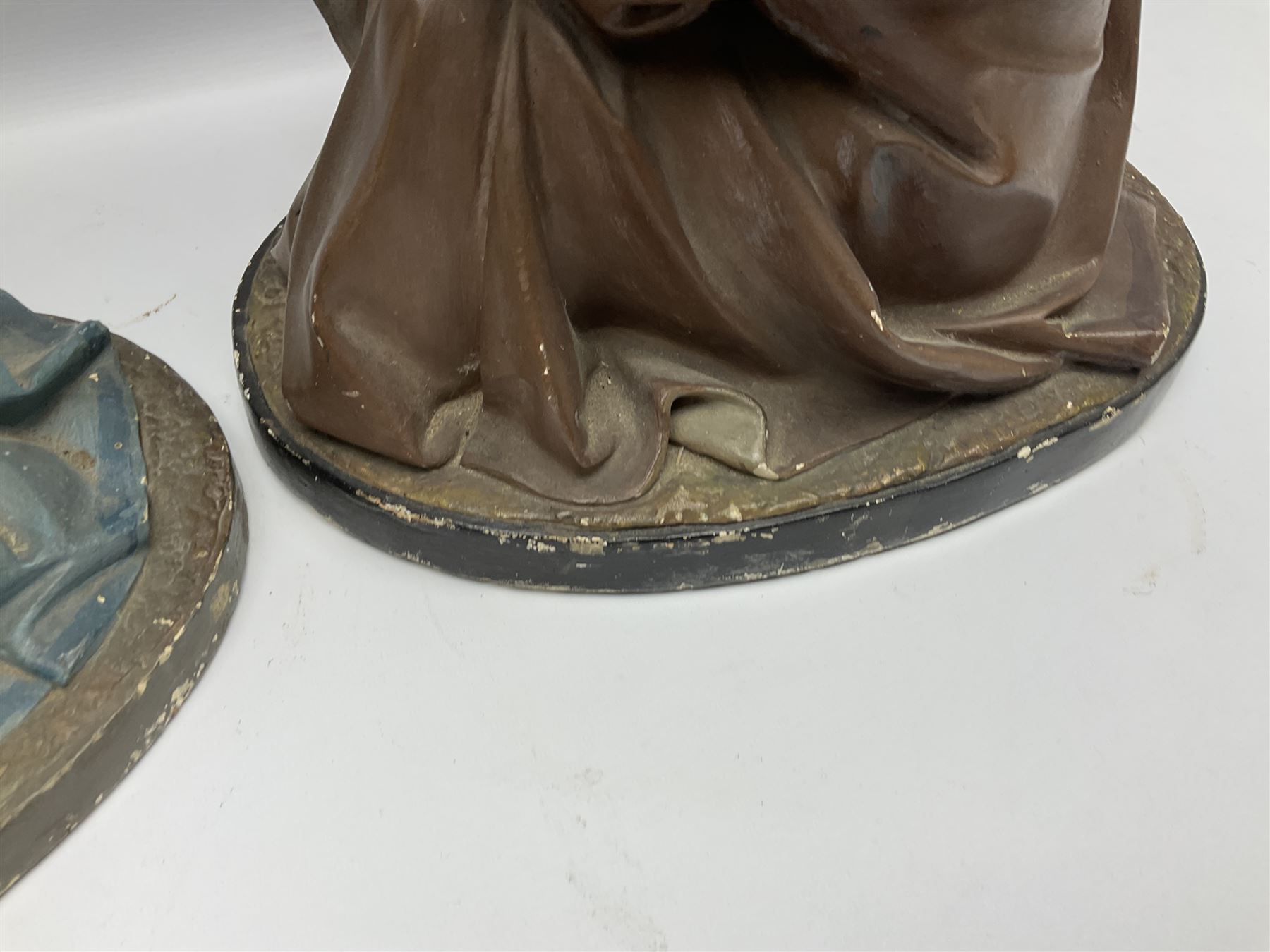 Two religious painted plaster figures of Mary and Joseph kneeling on oval plinths, with impressed mark 'Raffl et Cie Paris', H60cm 