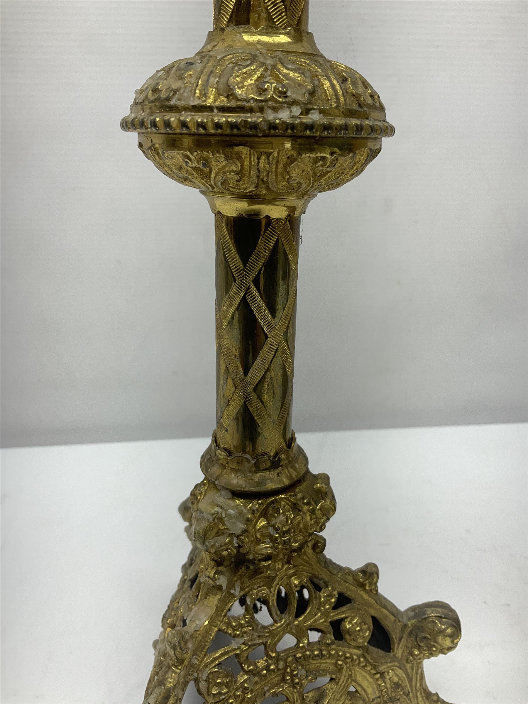 Pair of gilt metal pricket candlesticks, with applied decoration on knopt stems and triform bases, H47cm