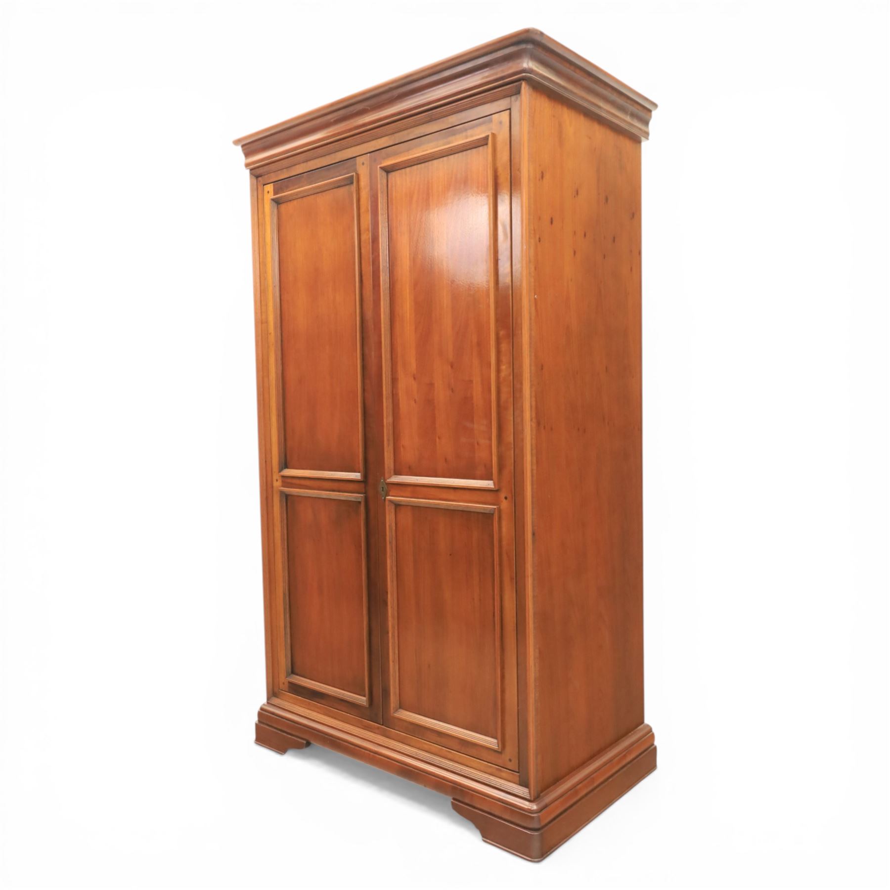 Willis & Gambier - French cherry double wardrobe, moulded cornice above panelled doors, enclosing a shelf and wooden hanging rail, raised on a moulded plinth with bracket feet