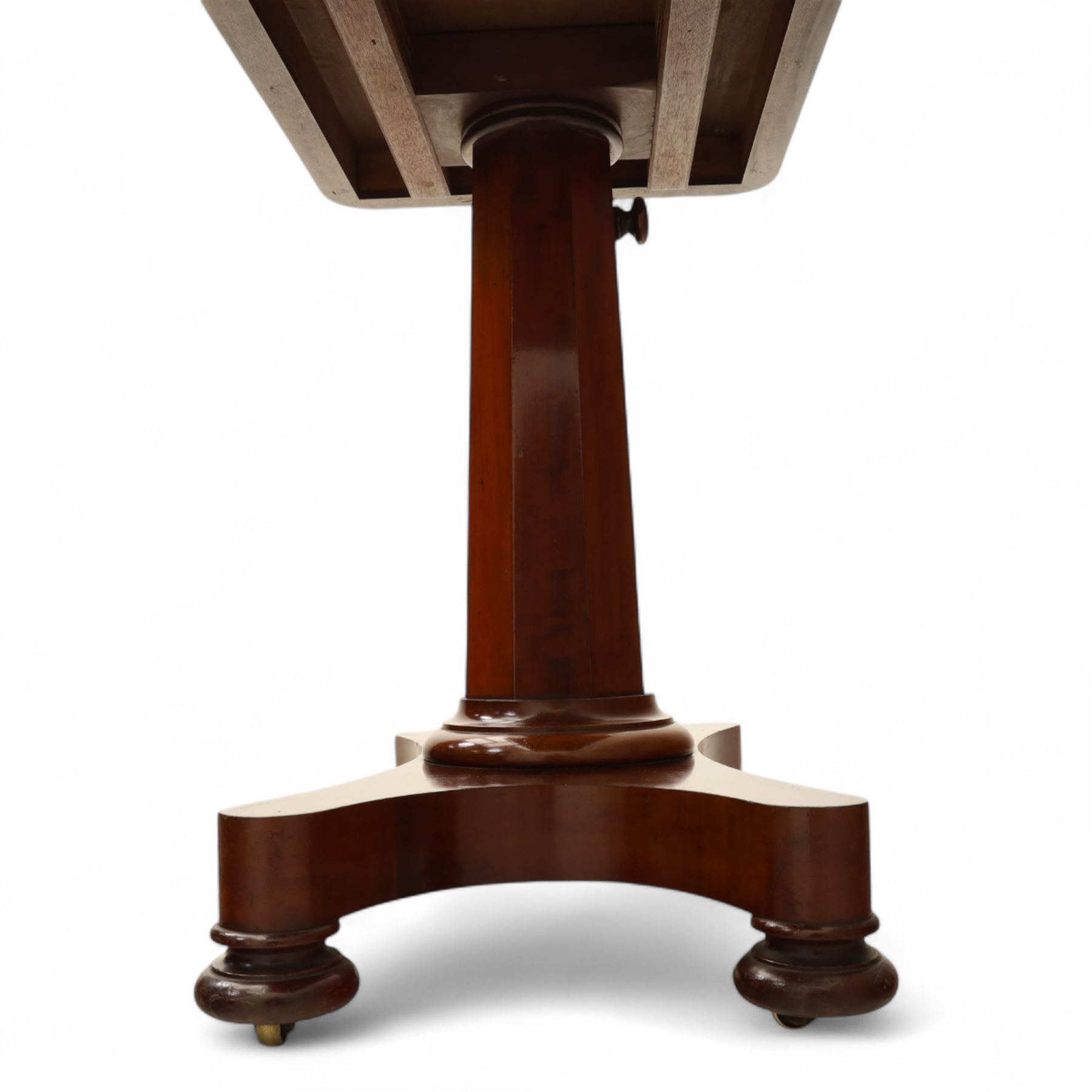 William IV mahogany reading table, the rectangular top with rounded corners and moulded edge, one end fitted with two hinged adjustable reading slops with two rests, the sliding top with a sprung stay mechanism, supported on a single tapered faceted column  with turned collar on a quatreform base with compressed bun feet
