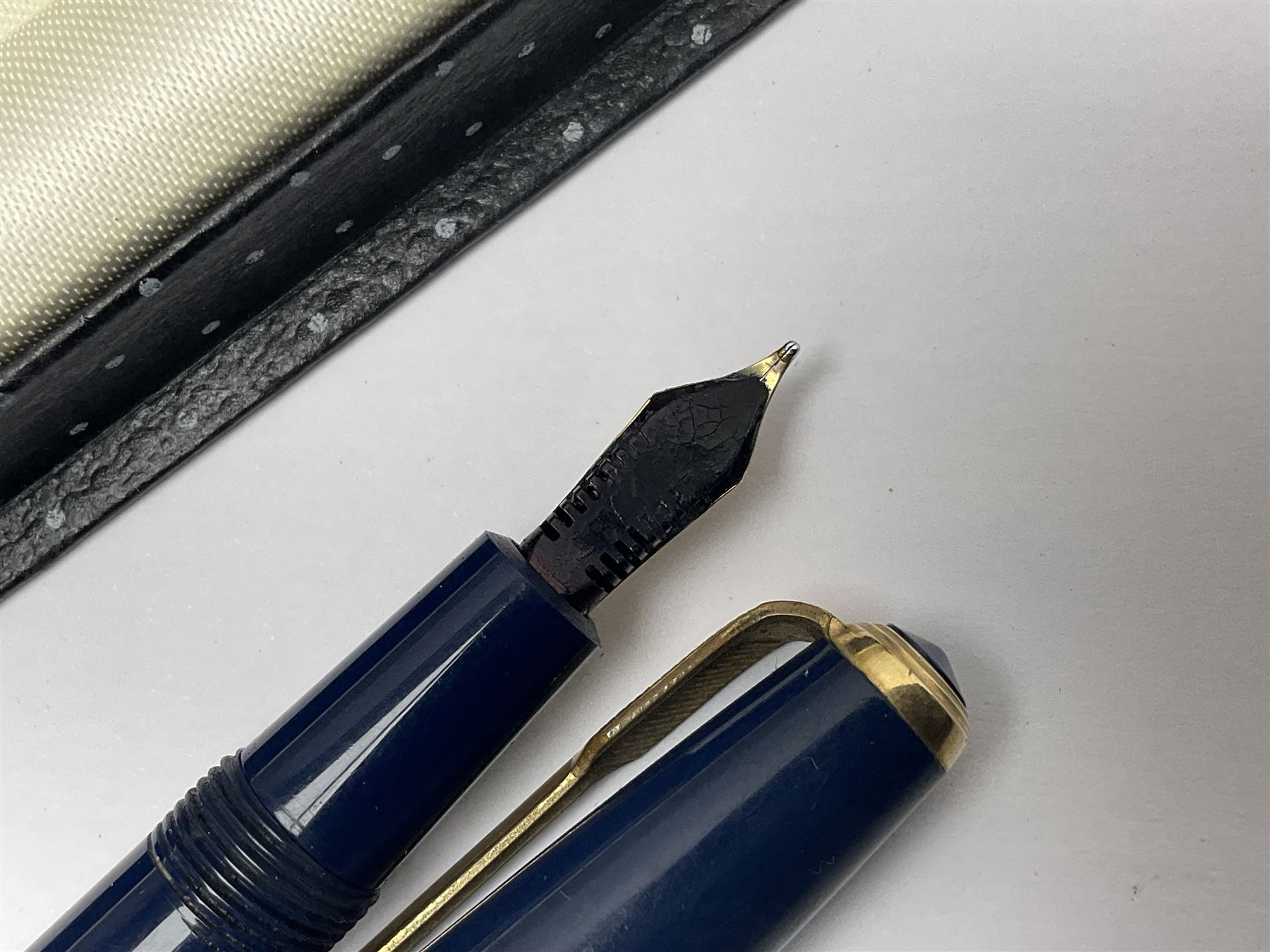 Three fountain pens, to include Conway Stewart 'Dinkie 550' and 'Conway 57' and a Parker 'Slimfold', all with 14ct gold nibs, together two roller ball pens, including a Parker example and a Swarovski Crystal paperweight