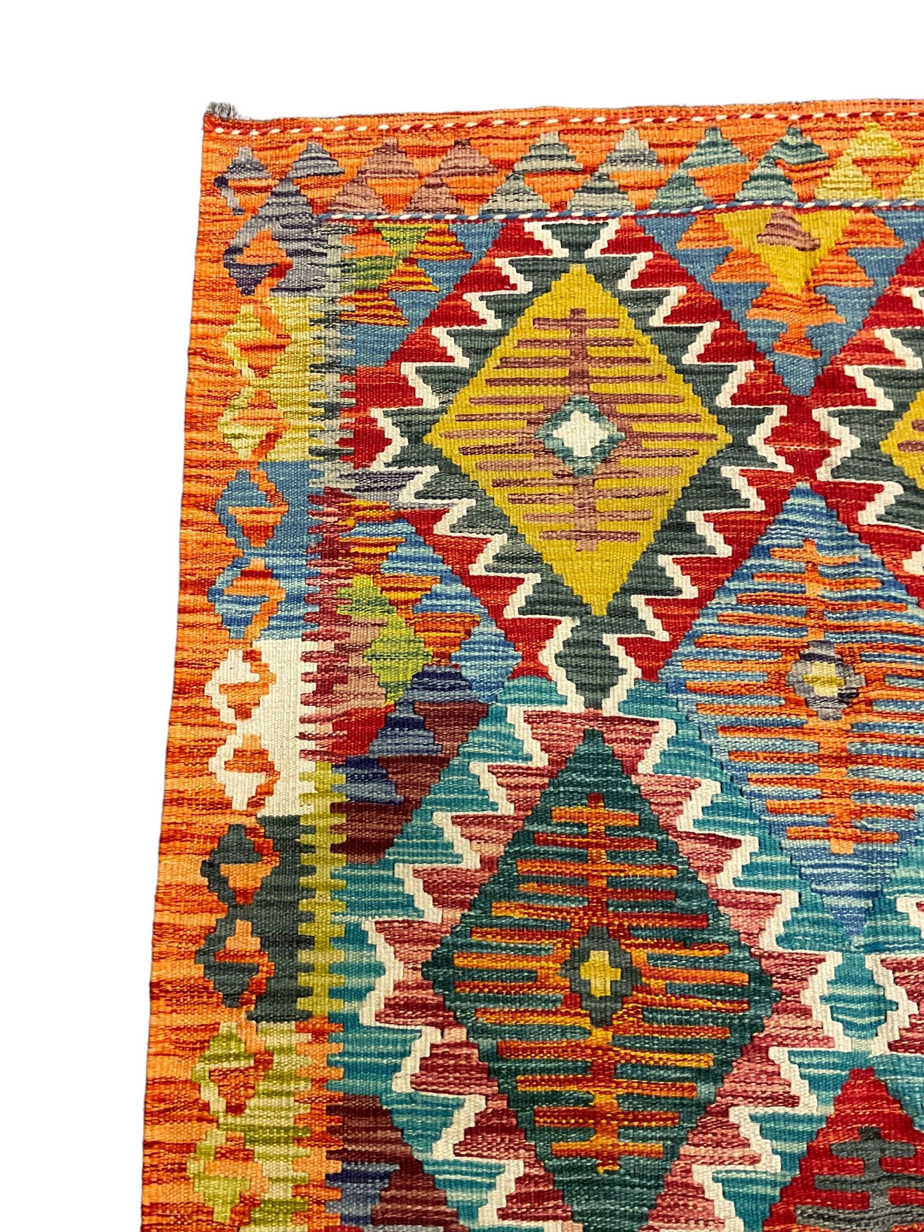 Chobi Kilim rug, multi-coloured ground in oranges, blues and greens, overall geometric design 