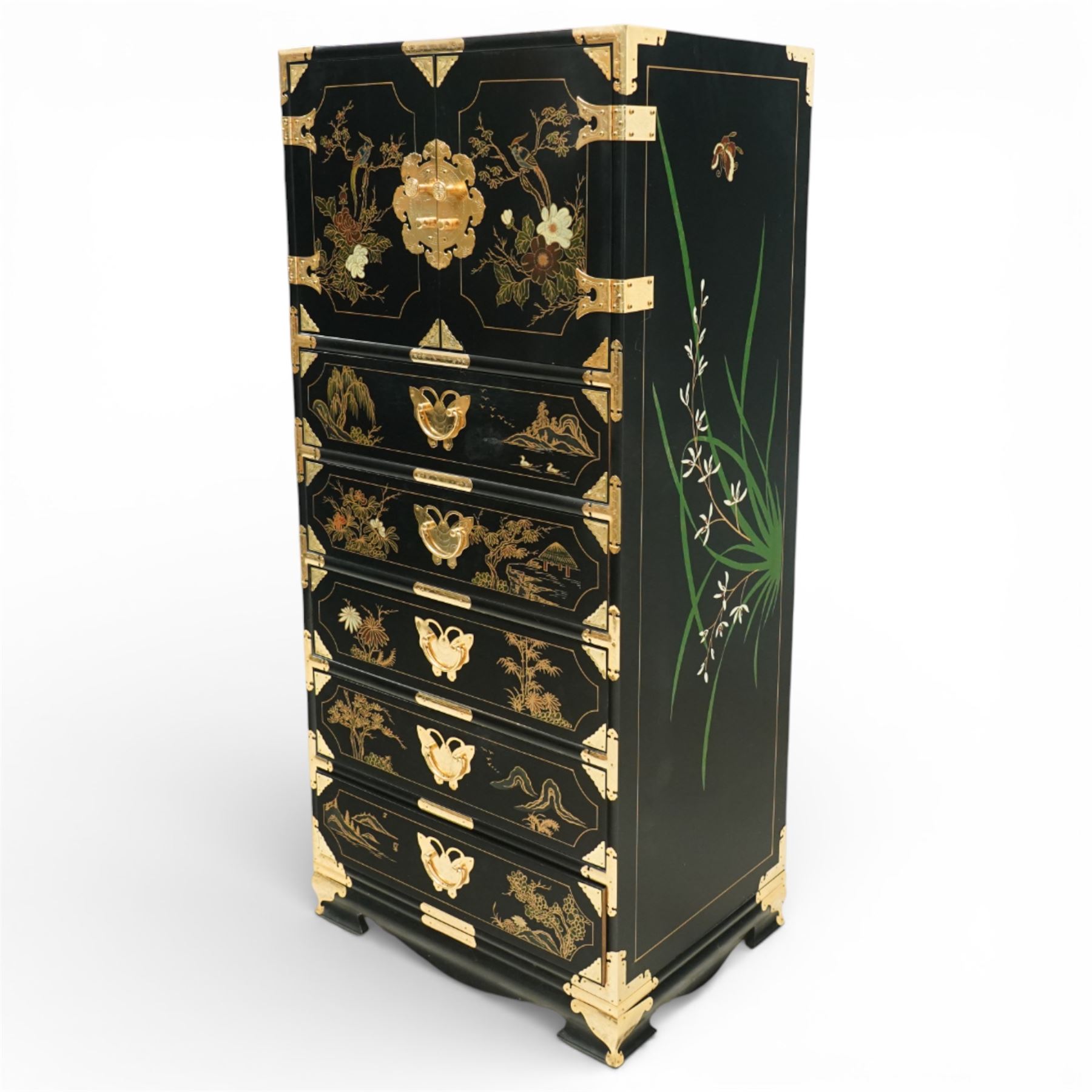 Japanese Shibayama style black lacquered curio chest, cupboard doors enclosing four short over two long fitted drawers, decorated in gilt with birds, flowers and landscape scenes, raised on gilt mounted bracket feet