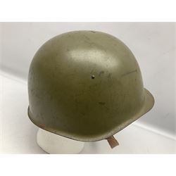 Two 1960s East Block Soviet style helmets - Czechoslovakian and Russian; both with liners (2)