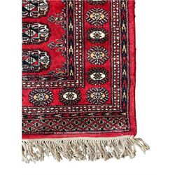Tekke Bokhara red ground rug, decorated with two rows on Gul motifs, geometric design borders decorated with stylised floral motifs 