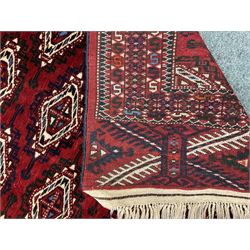 Bokhara red ground rug, repeating border, geometric patterned field