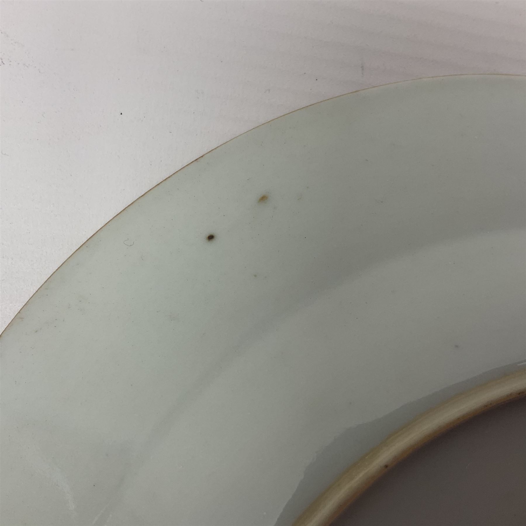 Three 18th century Chinese Famille Rose plates, the first example enamelled with blossoming peonies, rockwork and fence, the other two examples of similar design, decorated with blossoming peonies and sprigs within shaped inner borders, each approximately D23cm