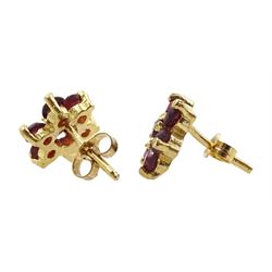 Pair of 9ct gold garnet flower stud earrings, stamped 375
