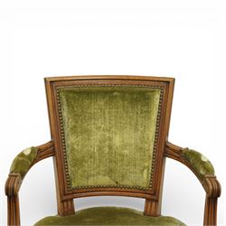 French Louis XVI style walnut armchairs, rectangular upholstered backs with nailhead trim, padded seats upholstered en suite, out-swept arms with upholstered pads, fluted supports with carved rosettes to the knees, on turned and fluted tapering legs