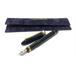 An Omas 360 fountain pen, the black triangular section body with gold coloured clip and banding, and Greek Key border to the cap, the bicolour nib marked 750 18K.