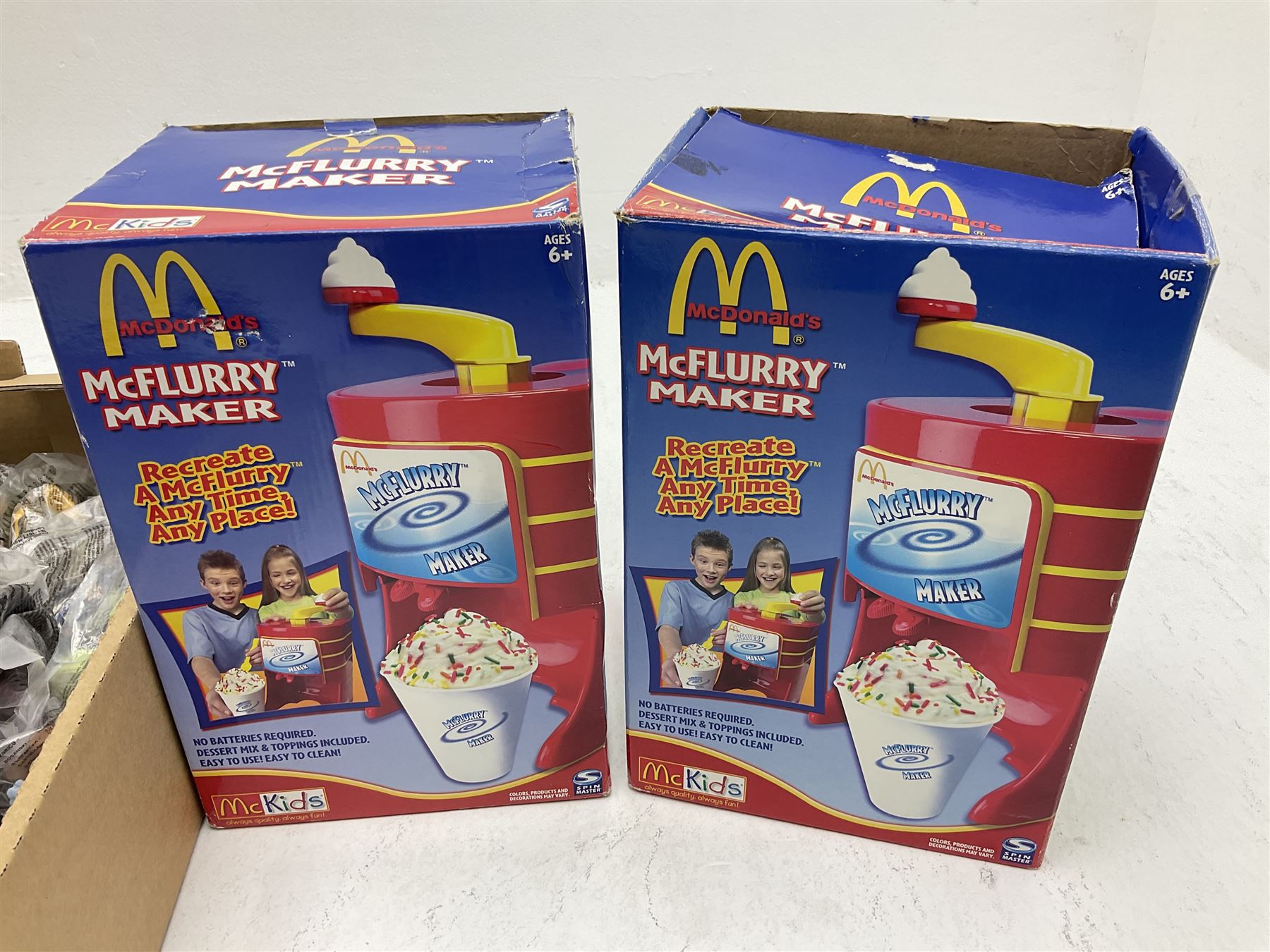 Quantity of Mcdonalds toys and two boxed Mcflurry makers in two boxes