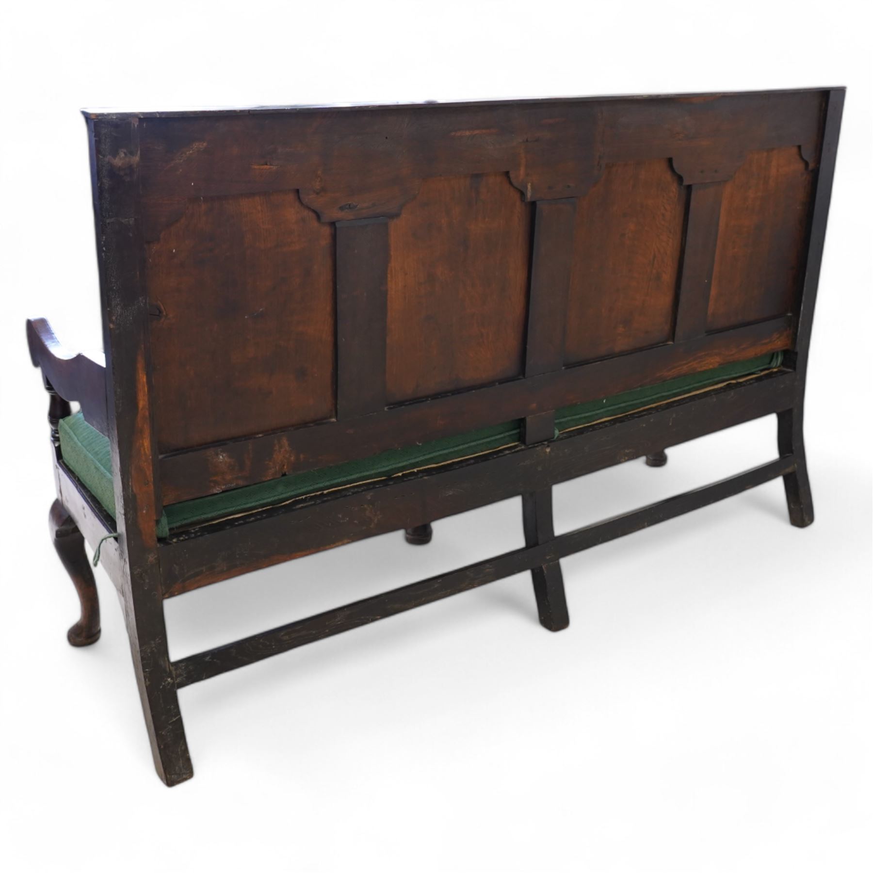 18th century oak settle or hall bench, moulded cresting rail over quadruple fielded panelled back, shaped arms over loose squab cushion upholstered in patterned teal fabric, plain frieze rail over cabriole front supports
