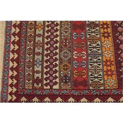 
Oman tribal design rug, field decorated with horizontal bands of stylised birds, flowerheads, stars and hooked geometric motifs in red, ivory, ochre and pale blue, enclosed by serrated ivory and red borders and narrow patterned guard stripes