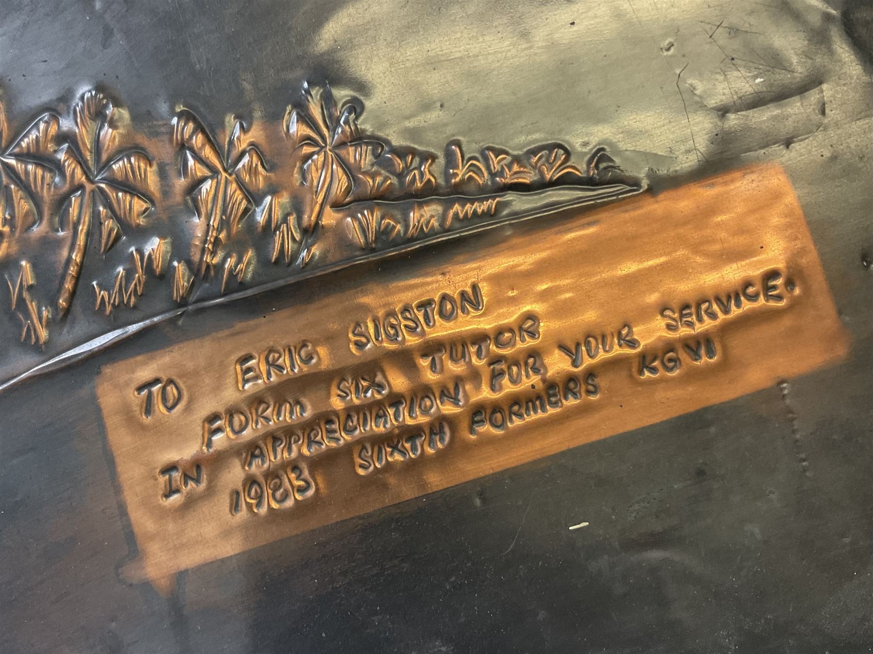 Collection of traditional necklaces from the Solomon Islands, including shell and boar tusk examples, together with a carved canoe prow, with mother of pearl eyes, painted cow hide and a copper plaque, depicting the Solomon Islands, with presentation engraving