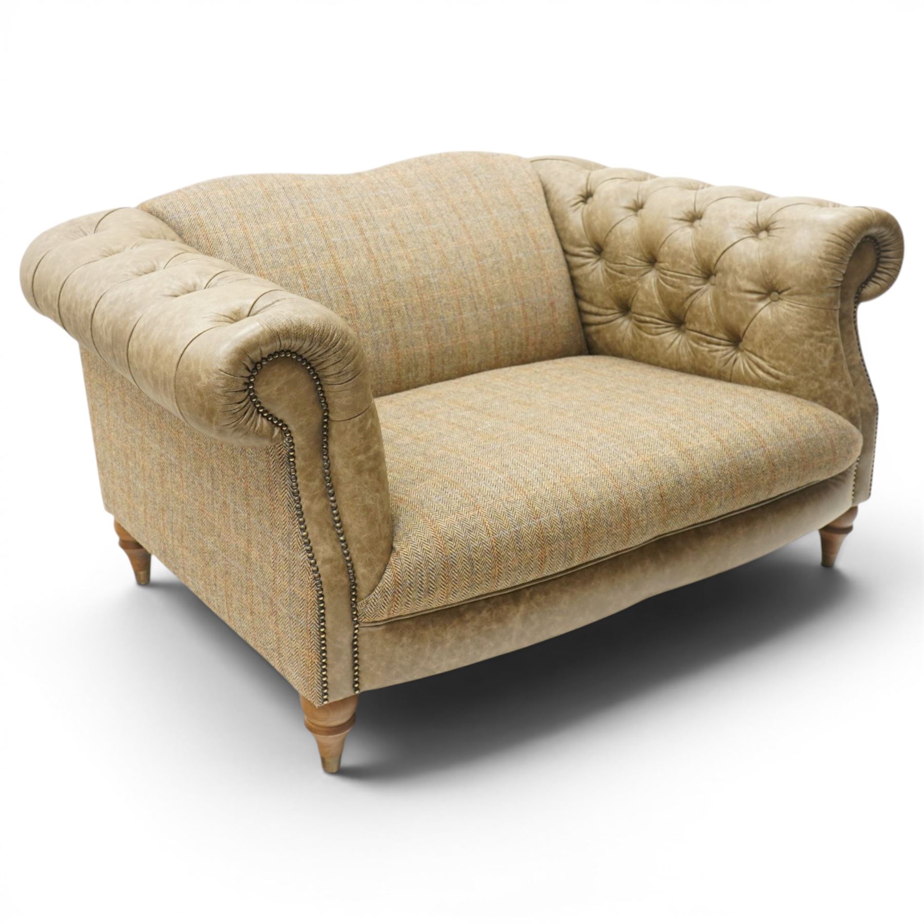 Tetrad - 'Matisse' snuggler armchair or loveseat, Chesterfield shape with rolled arms flanking a serpentine back and front, upholstered in herringbone pattern Harris Tweed and tan leather with close-nailed studwork, on turned feet