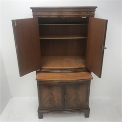 Reproduction Bevan Funnell mahogany serpentine front cocktail cabinet, two cupboards enclosing fitted shelves, single slide above two drawers and two cupboards, shaped bracket supports, W77cm, H153cm, D48cm