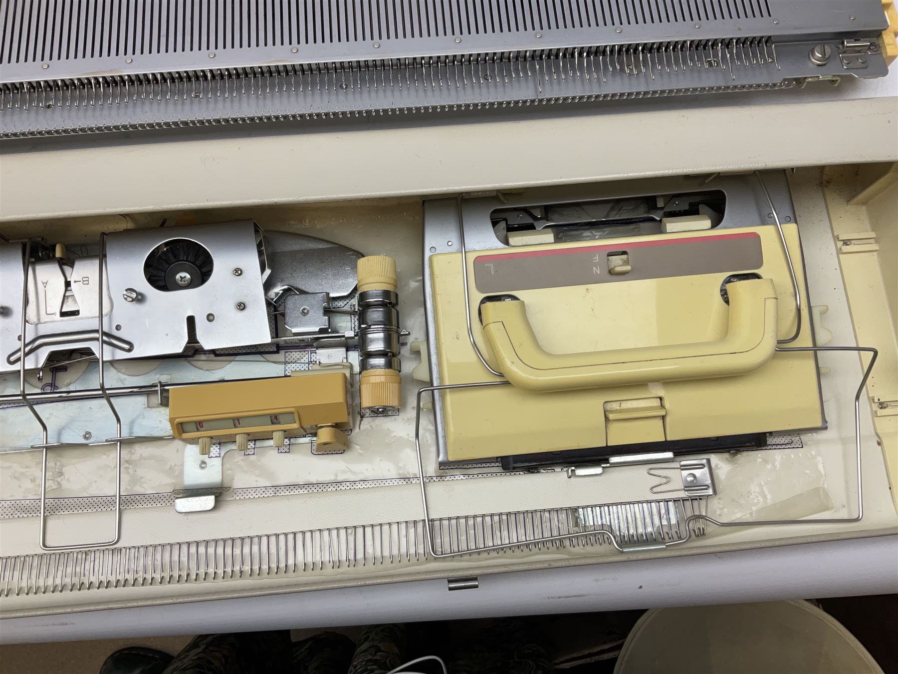  Brother cased knitting machine model KH-890 together with Brother Ribbing attachment model KH-850, knitting machine yarn cones in assorted colours, selection of knitting patterns etc