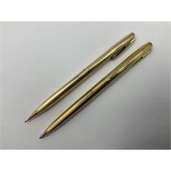 Sheaffer Triumph Imperial fountain pen, the gold plated barrel with fluted stripe design and gold nib stamped 14K 585, together with a Sheaffer Targa slimline fountain pen with gold plated barrel similarly decorated with gold nib stamped 14K 585, ballpoint pen and propelling pencil, each with a fluted gold plated barrel, largest L13.5cm (4)