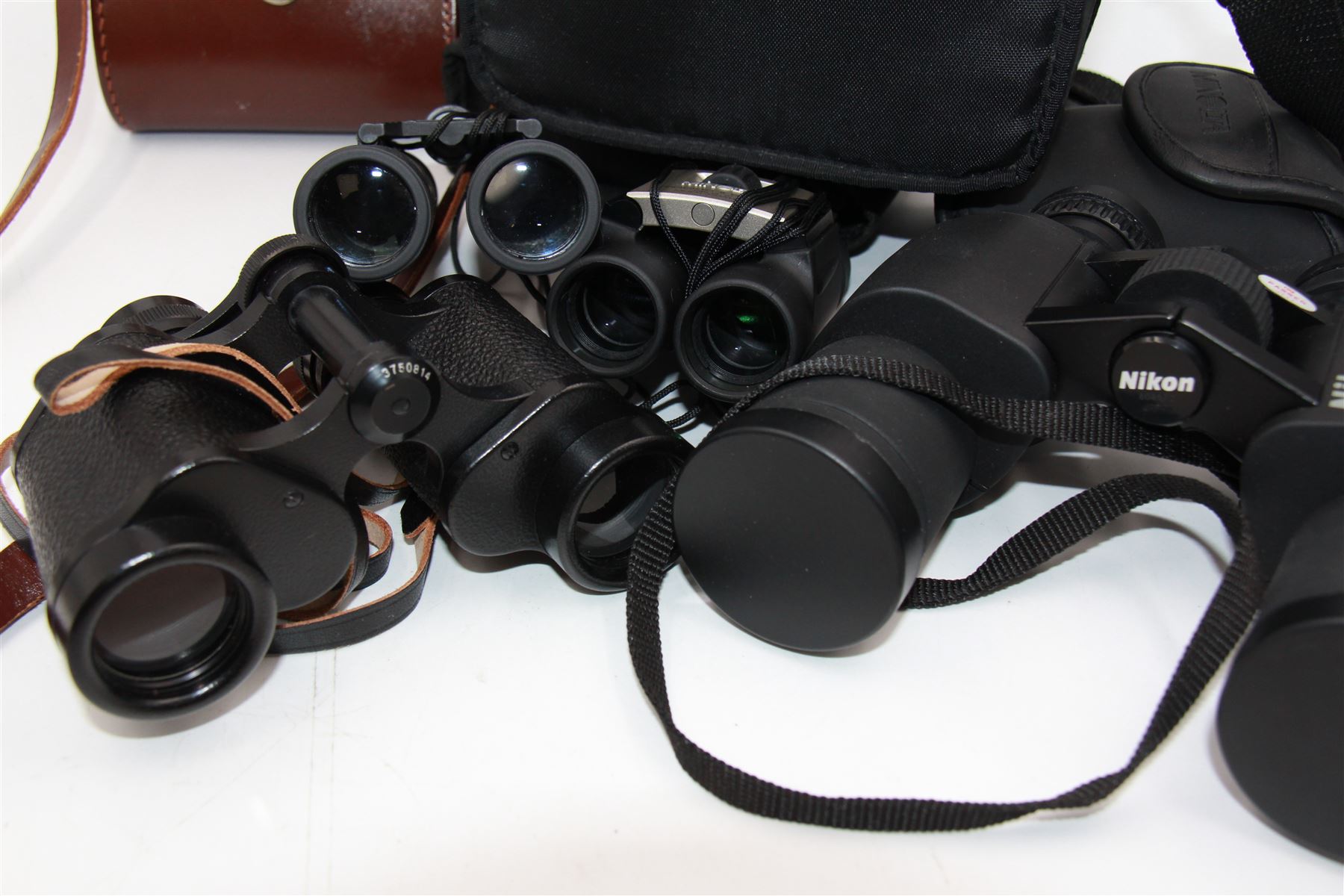 Four pairs of binoculars, to include Carl Zeiss Jena Jenoptem 8x30W serial no. 3750814, Nikon Sporting II 8x40 serial no. 604672, Minolta Pocket II 8x22 Field 7 and Jessops 12x25 Field 4.8 84m/1000m, all in carrying cases 