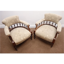  Pair late Victorian walnut framed tub shaped chairs, upholstered in a beige floral fabric, carved scrolled arms, turned supports  