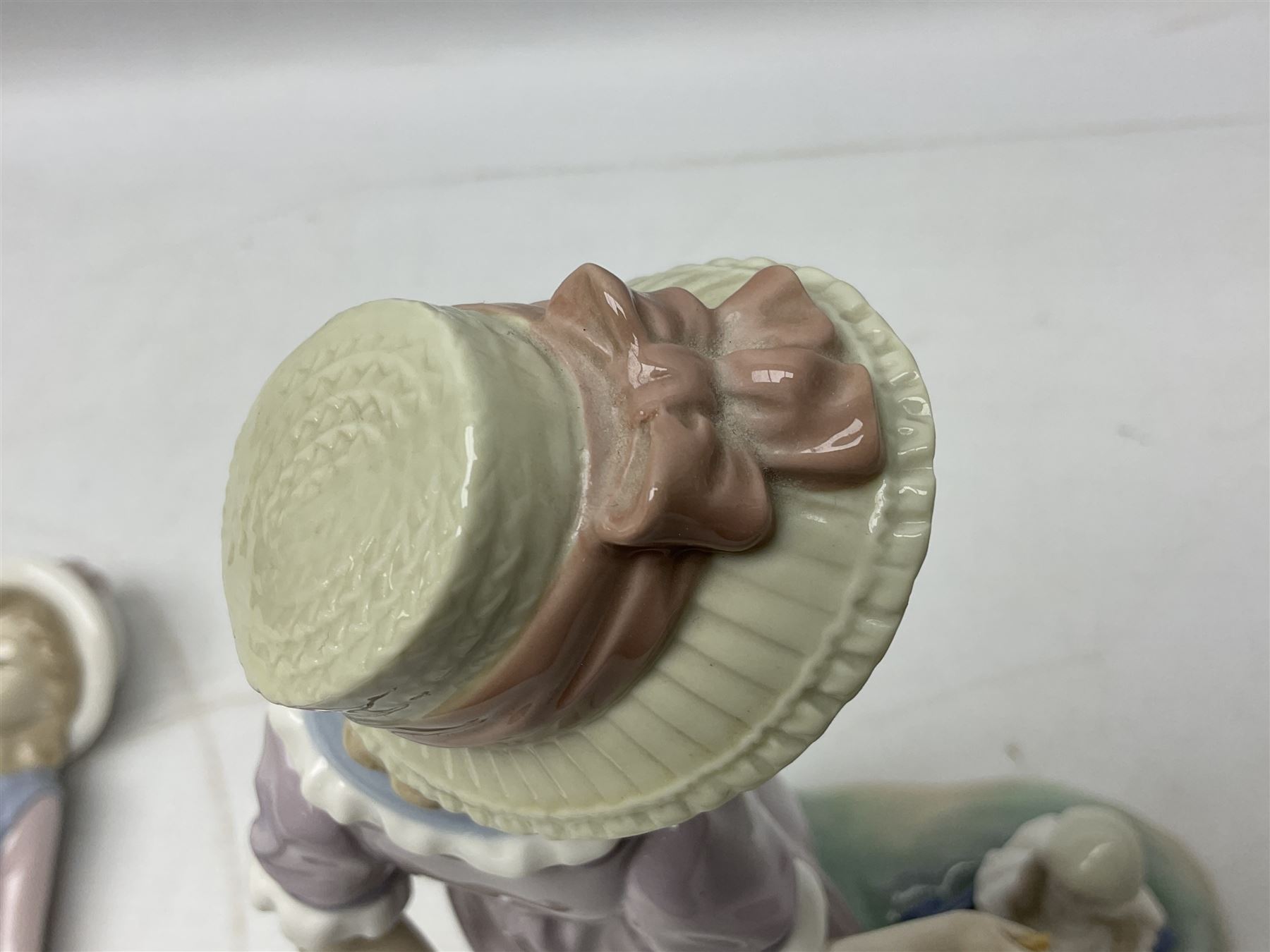 Four Lladro figures, comprising Pulling Dolls Carriage no 5044, Belinda with her Doll no 5045, Pretty Pickings no 5222 and Shepherdess with basket no 4678 