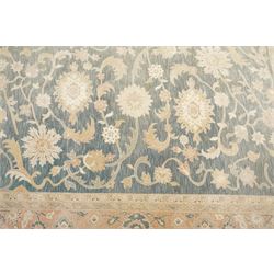 Indo-Persian indigo ground carpet, the field decorated with large palmette motifs connected by scrolling foliate, enclosed nu wide guard bands decorated with repeating interlaced stylised plant motifs