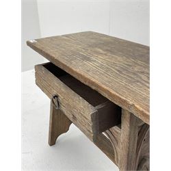 20th century oak occasional table/stool, plank top over single drawer, the end supports carved with Gothic arches