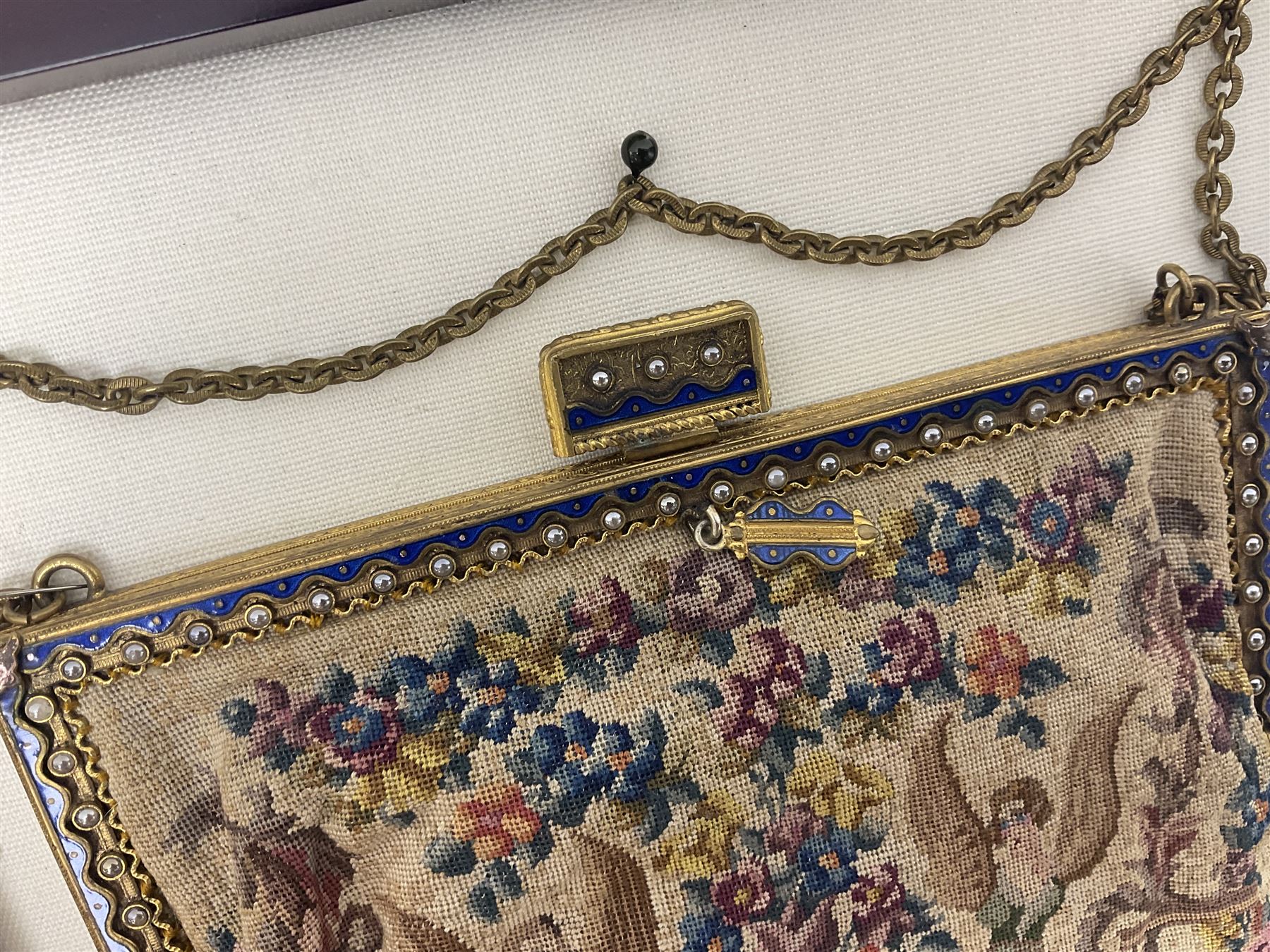 Continental petit point evening bag, with enamel and pearl details, in wooden display frame, together with a snake skin handbag and three other vintage bags