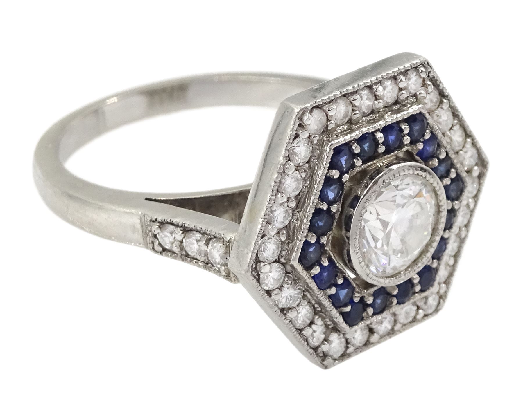 Platinum milgrain set diamond and sapphire hexagonal ring, the principle diamond of approx 0.55 carat, with sapphire and round brilliant cut diamonds, hallmarked