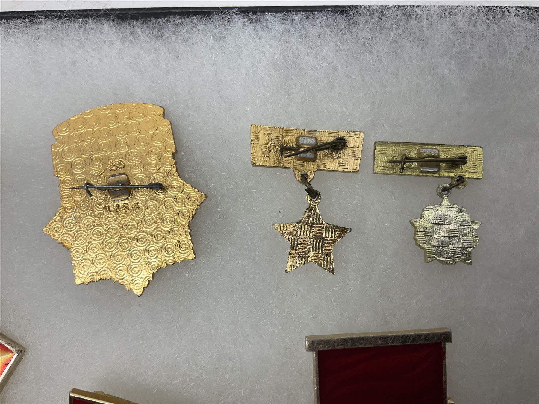 Nineteen Russian Soviet Tank Commemoration badges and medals, in small display case