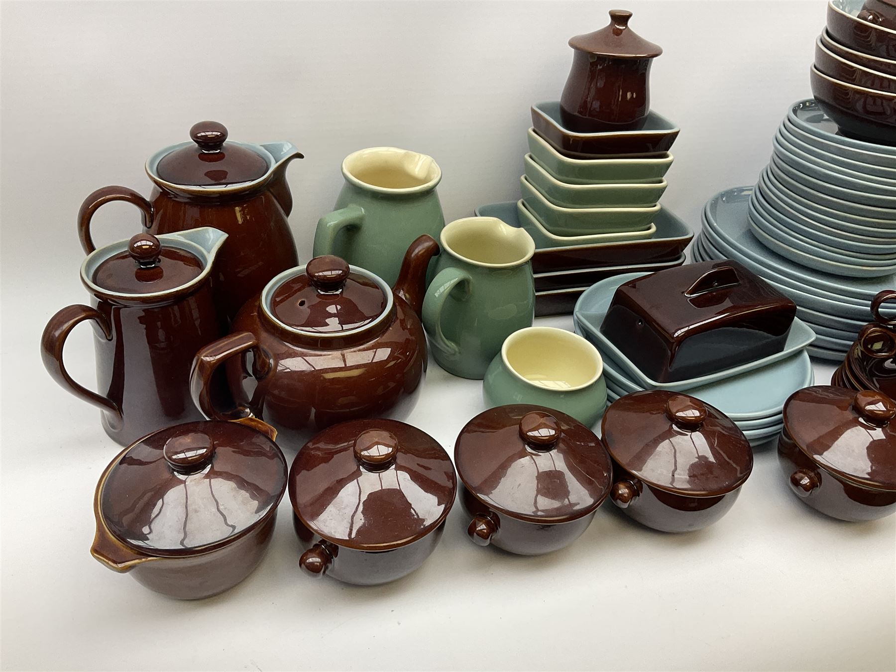 Denby dinner and tea wares, comprising largely Homestead pattern, to include dinner plates, salad plates, serving plates and dishes, bowls, teapot, coffee pot, hot water pot, teacups, saucers, milk jug, etc. 