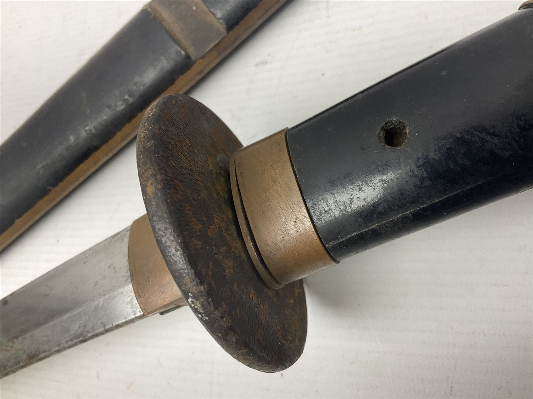 Good quality Japanese sword blade with later WWII fittings and scabbard  - 67.5cm slightly curving blade with unmarked tang, plain iron tsuba and lacquered grip with copper mounts; in lacquered wooden scabbard with tape bound tip L94cm overall