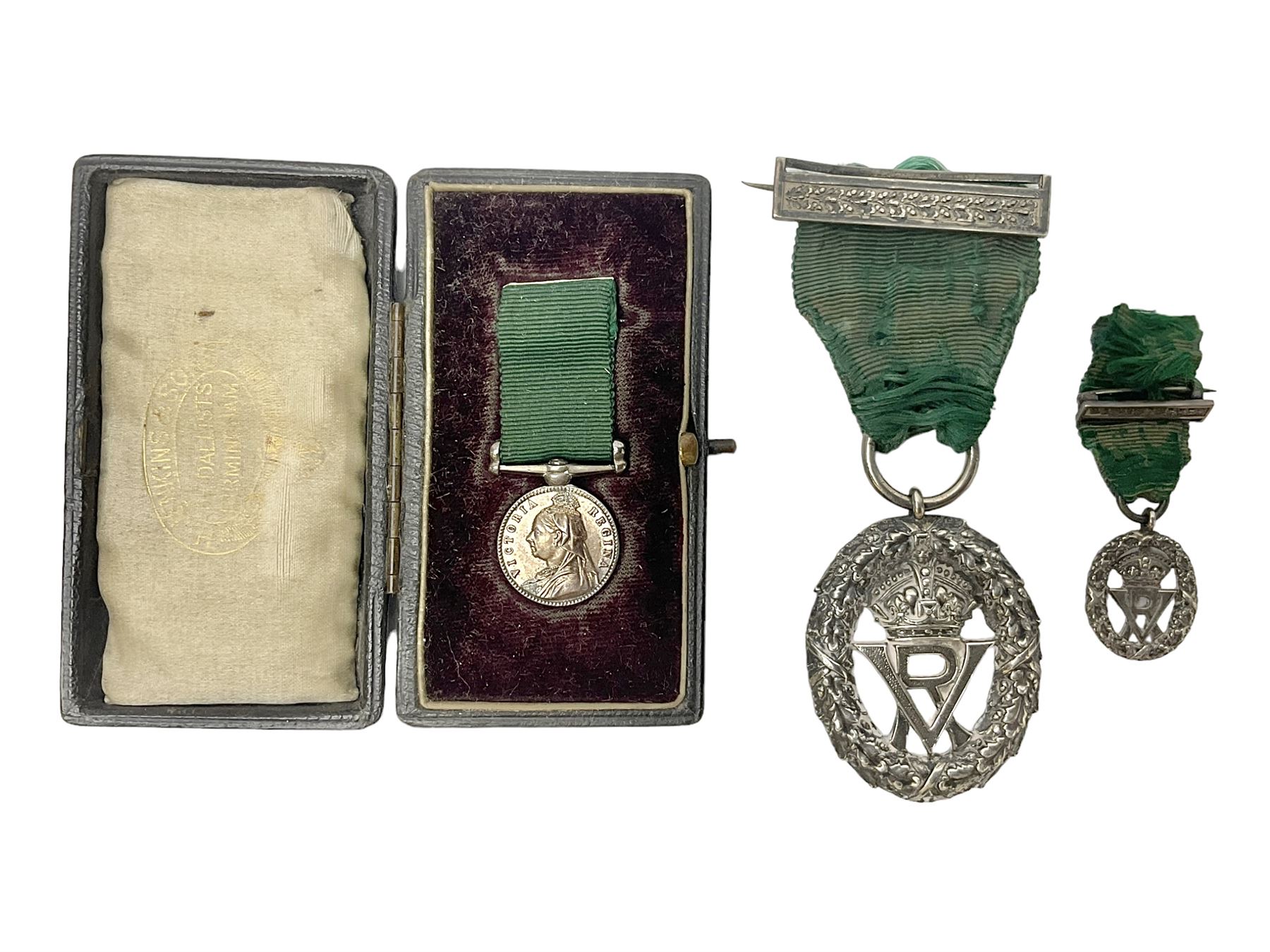 Victoria Volunteer Officers’ Decoration, V.R. cypher, hallmarked silver London 1892, with integral top riband bar and ribbon, unnamed; the matching miniature; and Victoria 'For Long Service in the Volunteer Force' miniature medal with ribbon in original case (3)