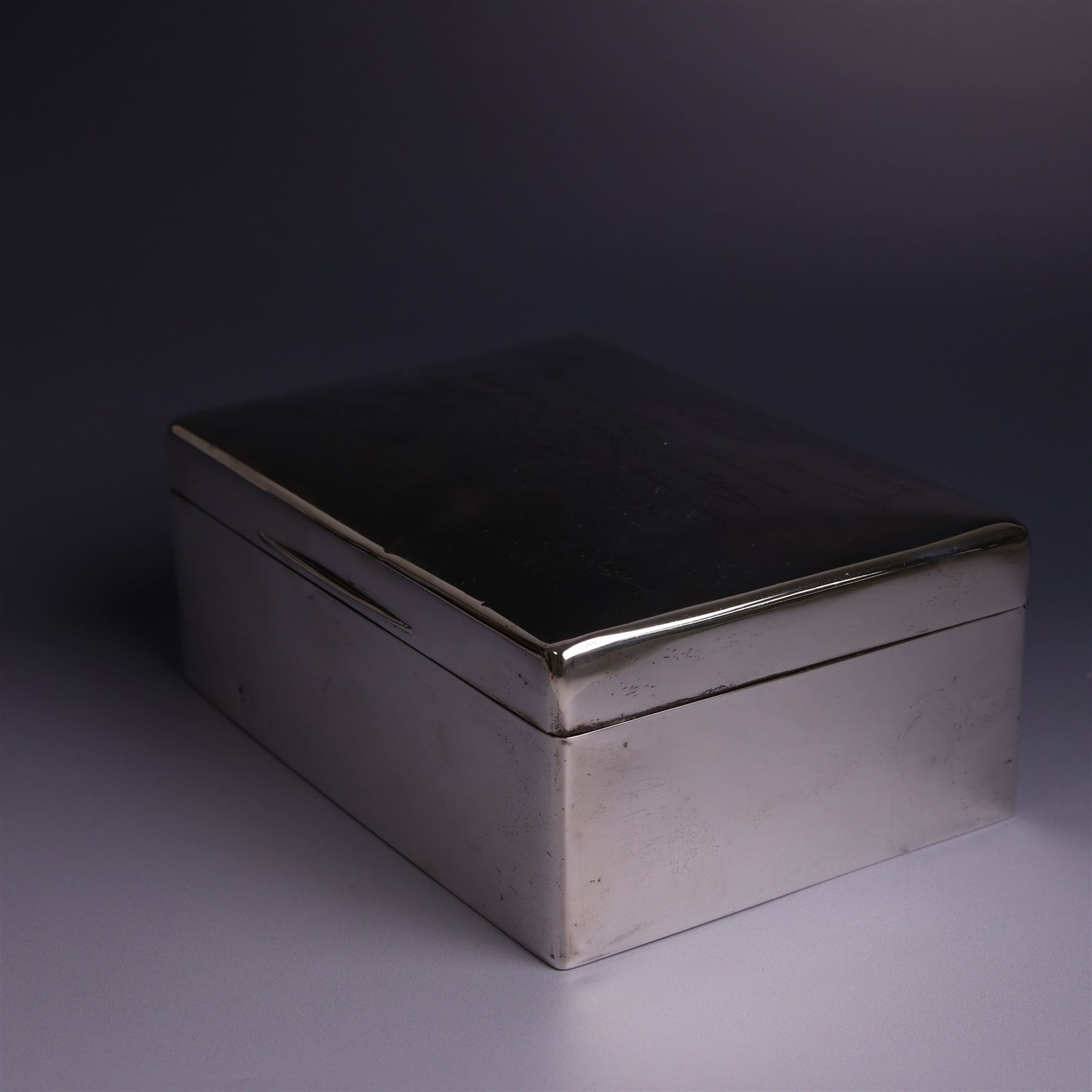 WWII silver mounted cigarette box, of rectangular form, the hinged cover inscribed 'presented to Major & Mrs James Bennett on the occasion of their marriage by the officers of the Liverpool Wardens Service October 1944' and engraved with twenty-four signatures of the officers, with softwood interior, hallmarks worn and indistinct, H7.5cm, W19cm