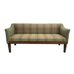 Late 19th century oak framed bench seat, upholstered in green and red tartan fabric, shaped arms over straight apron, raised on turned tapering supports