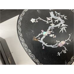  Late 19th / early 20th century Japanese lacquered table top cabinet, heavily decorated with mother of pearl inlay depicting blossoming branches, flowers and birds, the two hinged doors between longer drawers opening to reveal interior fitted with four short drawers, with lift up hinged canted lid, H28cm D9.5cm W23cm, together with mother of pearl inlaid miniature folding screen, dish decorated with walking figures with crimped edge, boxes decorated with flowers, birds and gilt etc